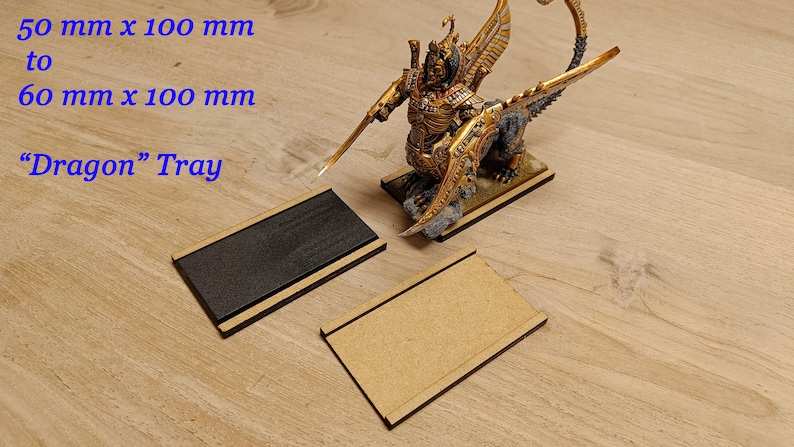 May include: Two wooden trays, one black and one natural wood, with a raised edge. The trays are 50 mm x 100 mm to 60 mm x 100 mm. The text "Dragon" Tray is visible in the image.
