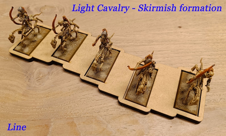 May include: Five miniature skeletal figures on horseback, painted in beige and brown, are arranged in a skirmish formation on a wooden base. The figures are holding bows and arrows. The text "Light Cavalry - Skirmish formation" is printed above the figures, and the text "Line" is printed below the base.