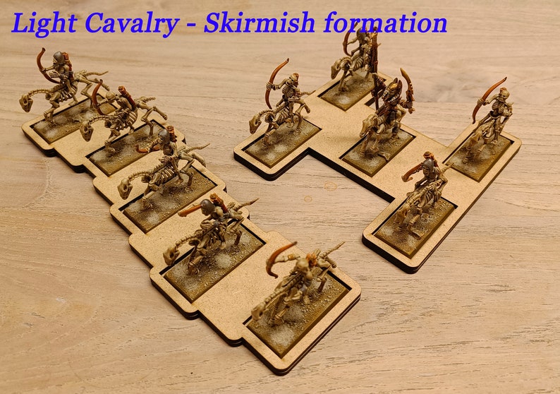 May include: A set of miniature skeletal cavalry figures in a skirmish formation on wooden bases. The figures are painted in shades of brown and gold, and they are holding bows and arrows. The text "Light Cavalry - Skirmish formation" is printed at the top of the image.