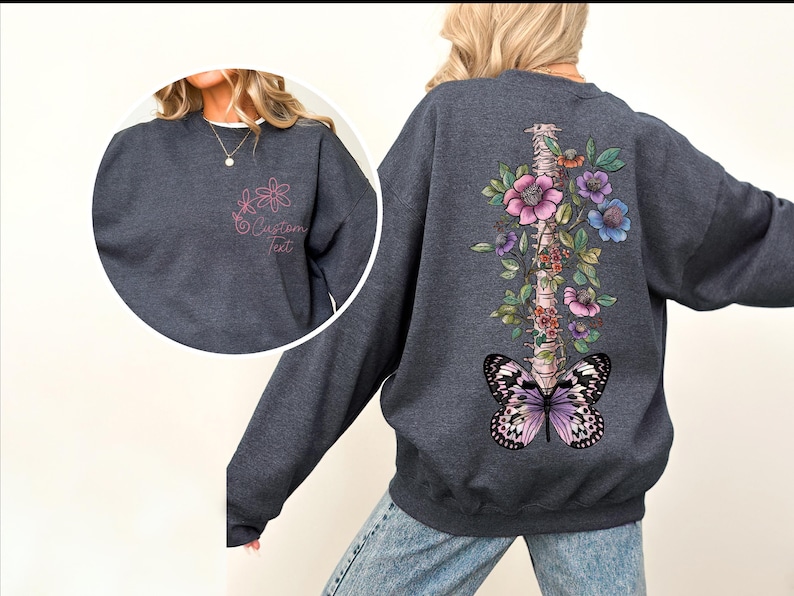a woman wearing a sweatshirt with a butterfly and flowers on it