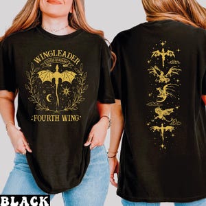 A woman wearing a black t-shirt with a graphic design featuring a dragon and the text "WINGLEADER FOURTH WING".