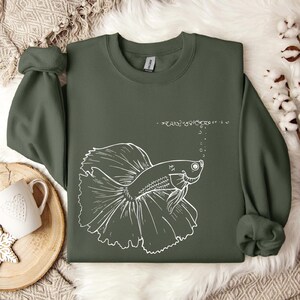 a green shirt with a picture of a fish on it