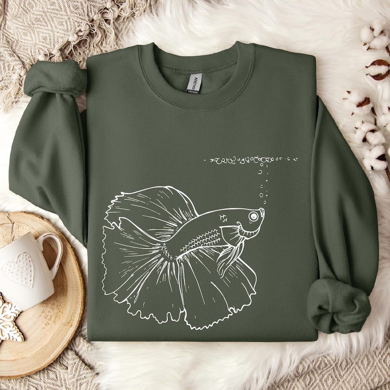 a green shirt with a picture of a fish on it