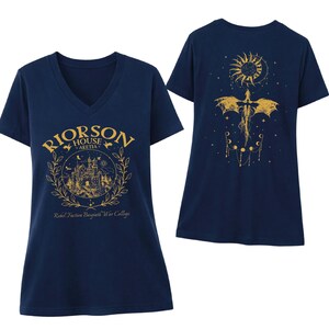 a navy blue t-shirt with a gold design on the front and back. The front design includes a castle and a dragon, while the back design features a sun and a moon. The text on the t-shirt reads "Rierson House Art College" and " Rebel Faction Bascatiqu War College".