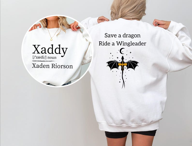 A person wearing a white sweatshirt with a dragon and text printed on the back.