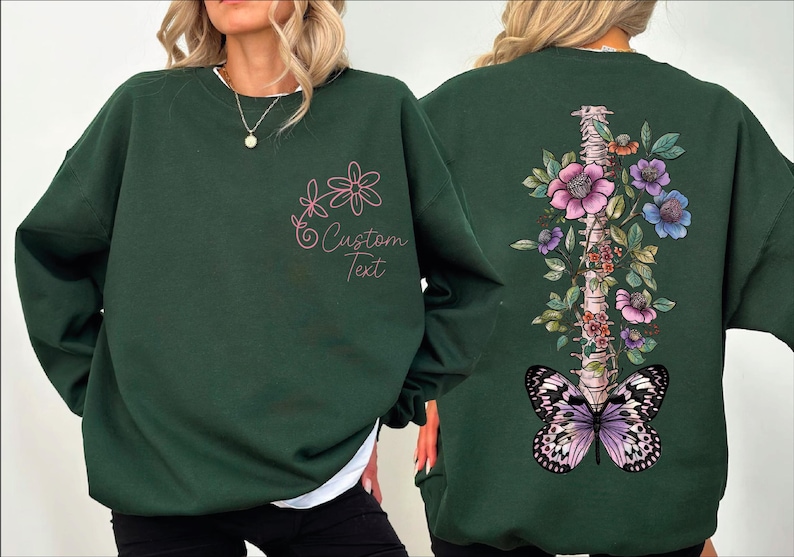 a woman wearing a green sweatshirt with butterflies on it