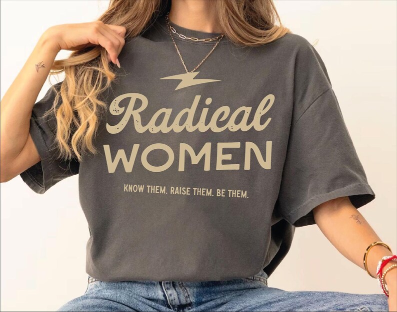 a woman sitting on a chair wearing a t - shirt that says radical women