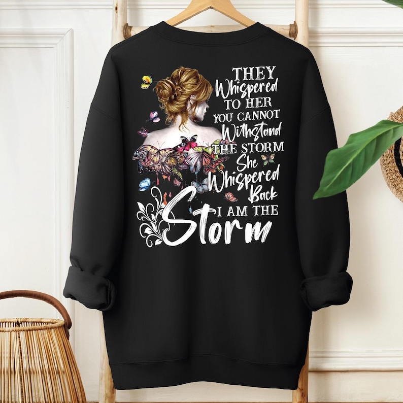 a black sweatshirt with a picture of a woman with flowers on it