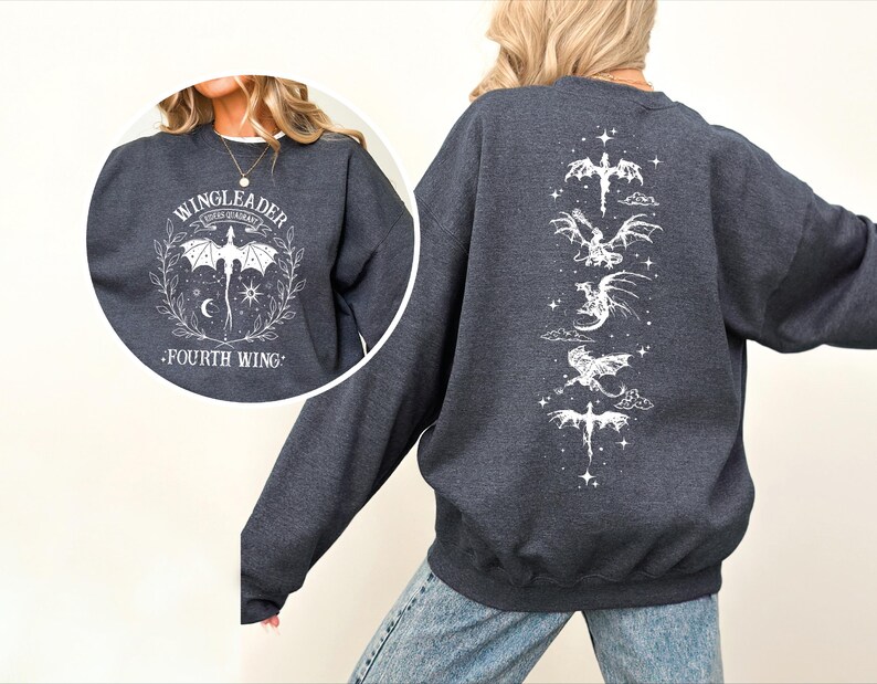 A person wearing a grey sweatshirt with a graphic design featuring a dragon and the text "WINGLEADER FOURTH WING".