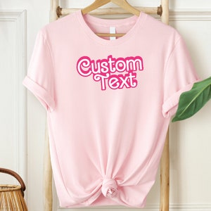 a pink shirt with the words custom text on it