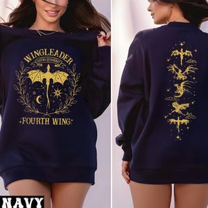 A woman wearing a navy blue sweatshirt with a graphic design on the front and back.