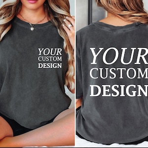 a woman sitting on a bed wearing a shirt that says your custom design