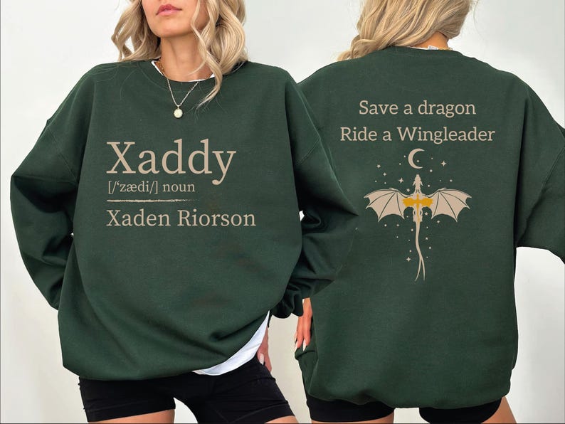 A woman wearing a green sweatshirt with text and graphics on the back.