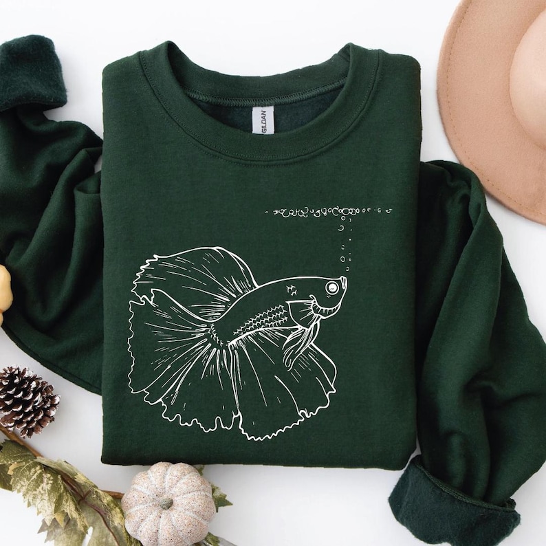 a green shirt with a picture of a fish on it