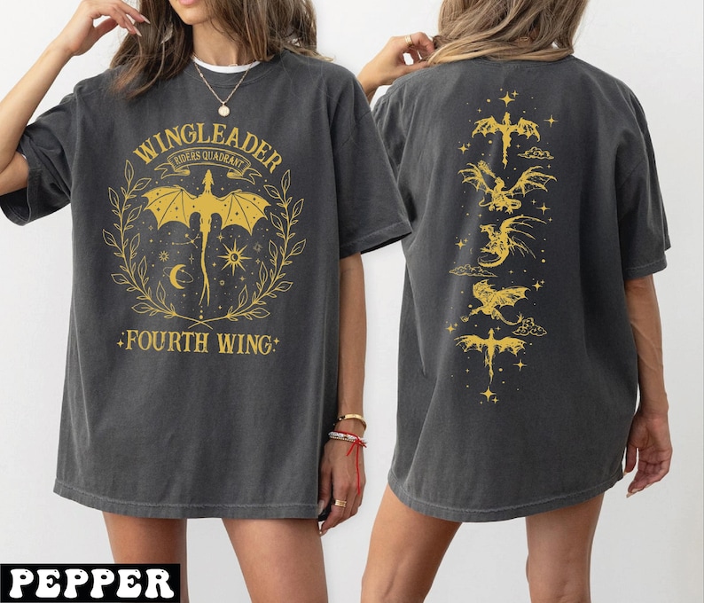 A woman wearing a grey t-shirt with a graphic design featuring a dragon and the text "WINGLEADER" and "FOURTH WING".