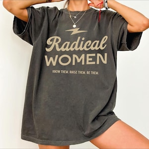 a woman wearing a black radical women shirt