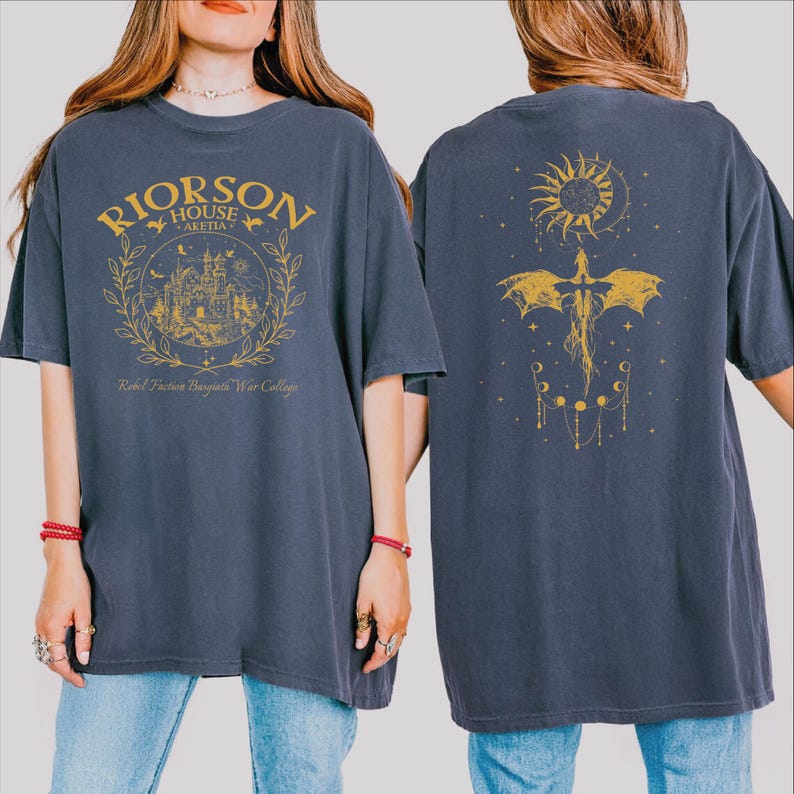 A woman wearing a gray t-shirt with a graphic design on the front and a dragon design on the back.