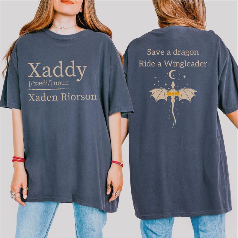A woman wearing a blue t-shirt with text and a graphic on the back.