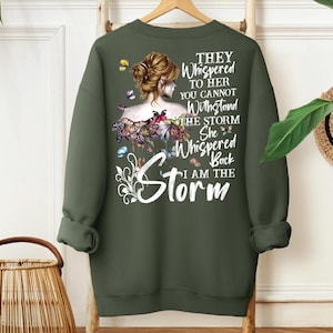 a green sweatshirt with a picture of a woman with flowers on it