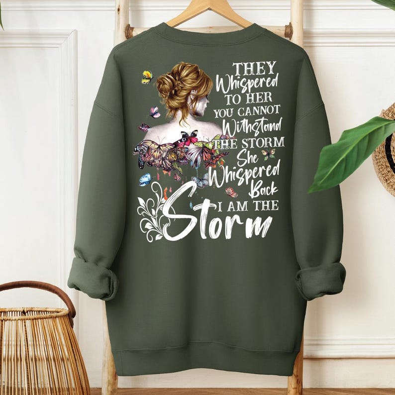 a green sweatshirt with a picture of a woman with flowers on it