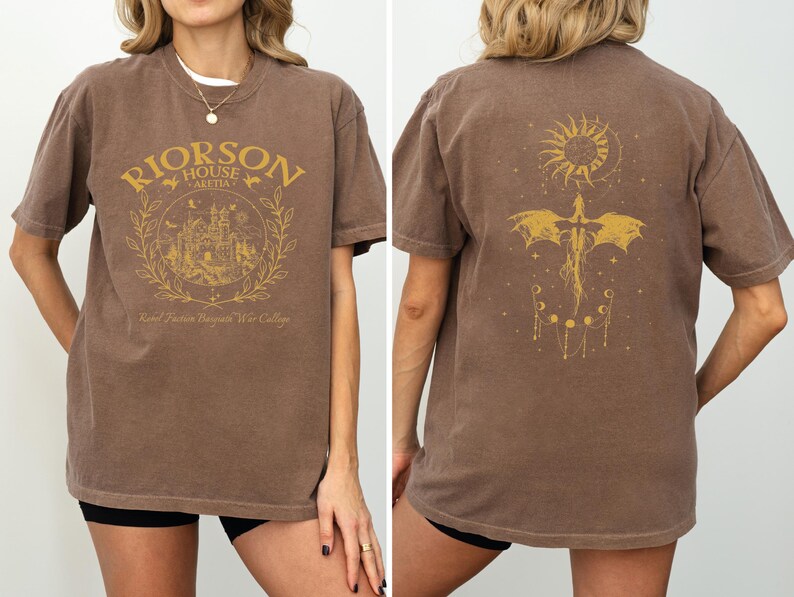 a woman wearing a brown t-shirt with a graphic design on the front and back.