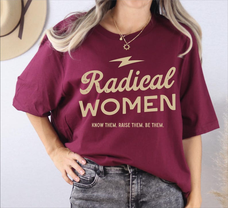 a woman wearing a red shirt that says radical women