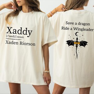 two people wearing white t-shirts with text and graphics on the back.