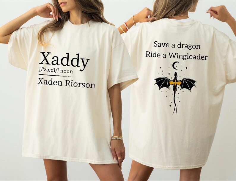 two people wearing white t-shirts with text and graphics on the back.