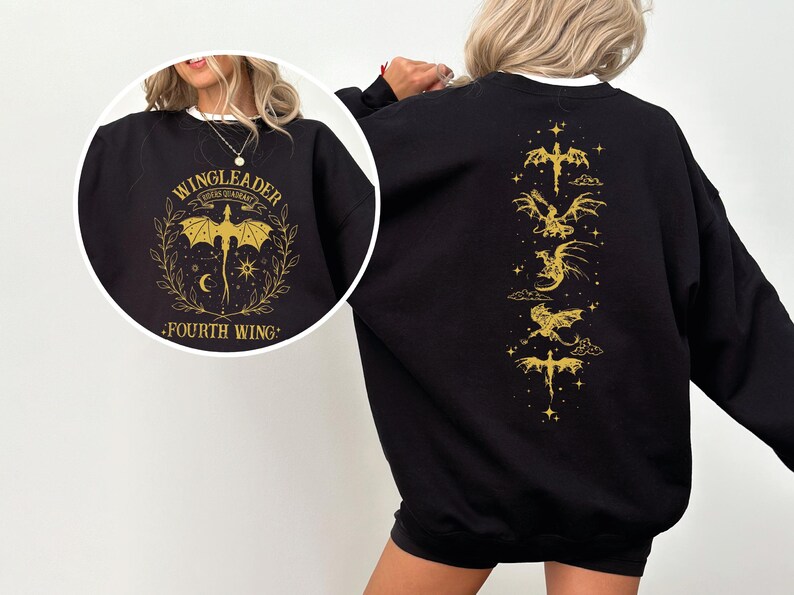 A woman wearing a black sweatshirt with a gold dragon design and text on the back.