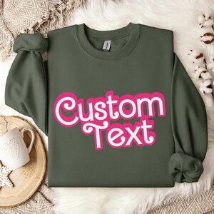 a green shirt with a pink custom text on it