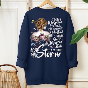 a blue sweatshirt with a picture of a woman's face on it