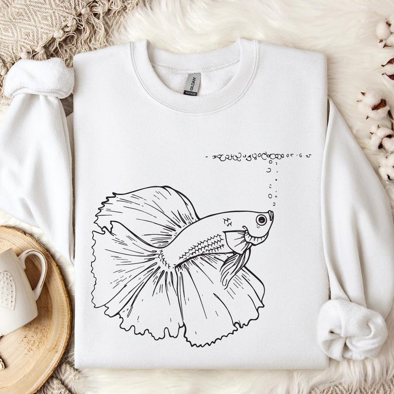 a white shirt with a drawing of a fish on it