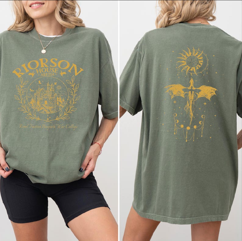 A woman wearing a green t-shirt with a graphic design on the front and back.