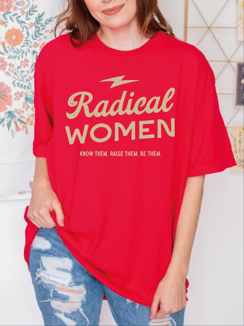 a woman wearing a red shirt that says radical women