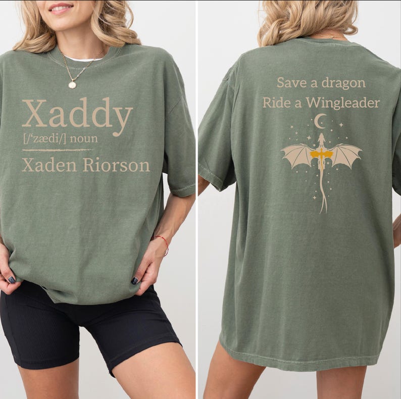 a woman wearing a green t-shirt with a dragon design and text printed on the back.
