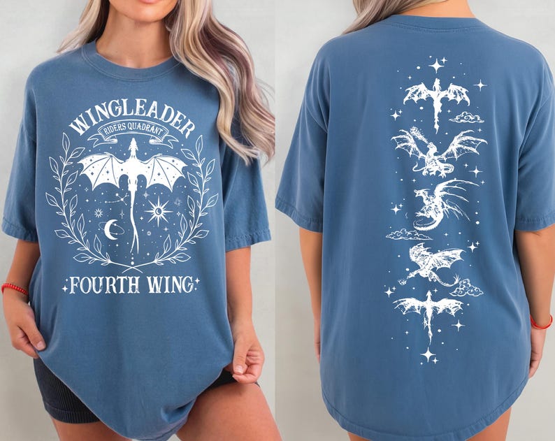 A woman wearing a blue t-shirt with a graphic design featuring a dragon and the text "WINGLEADER - RIDERS QUARANTINE".
