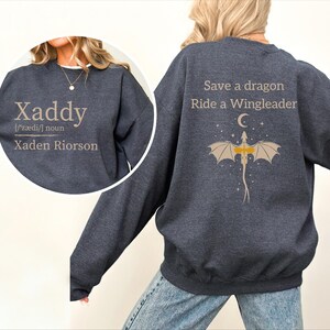 A person wearing a gray sweatshirt with text and a dragon graphic on the back.