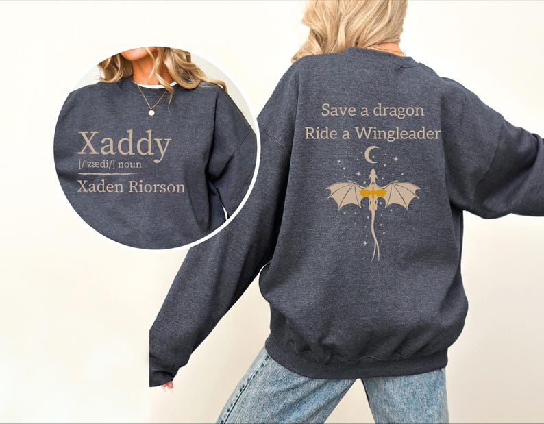 A person wearing a gray sweatshirt with text and a dragon graphic on the back.