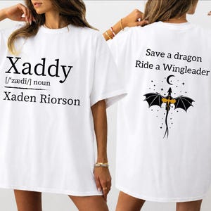 two white t-shirts with black text and graphics. The text on the t-shirts reads "Xaddy" and "Xaden Riordan" and includes a dragon graphic.