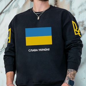 May include: A set of three ceramic mugs with a speckled, matte finish. The mugs are in shades of cream, light gray, and dark gray. Each mug has a simple, minimalist design, perfect for coffee or tea.