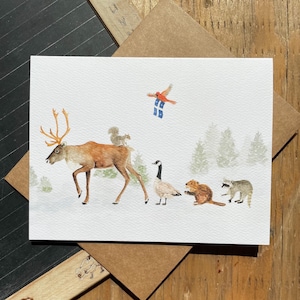 Mappa illustrata degli animali del Quebec: caribù, castoro, oca e procione con bandiera del Quebec, cartolina per la festa di San Giovanni Battista