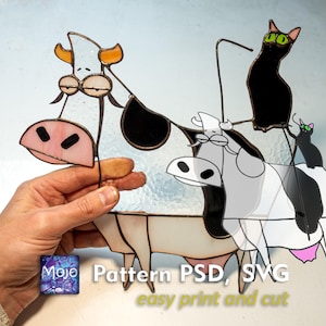 May include: A whimsical stained glass cow and cat design. The cow is white, black, and pink, with a surprised expression. Two black cats perch atop the cow. The text "Pattern PSD, SVG easy print and cut" is visible.