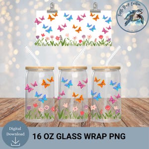 May include: Three clear glass cups with bamboo lids and straws, decorated with colorful butterflies and flowers. A matching design is on a white background held by clips. The text "16 OZ GLASS WRAP PNG" is at the bottom.