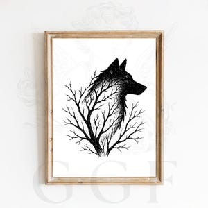 May include: A framed black and white art print featuring a detailed ink illustration of a wolf head emerging from the silhouette of bare tree branches. The artwork is contained within a light brown wooden frame against a plain white background.