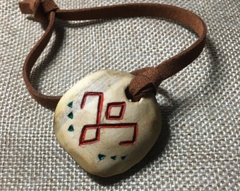 Necklace-pendant-talisman. Amulet made from the sacred linden tree. Runic signs. Paganism.
