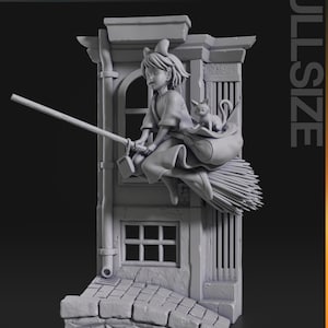 May include: A grey 3D printed figurine of a young woman with a cat riding a broomstick, flying out of a window of a building. The figurine is on a base with a cobbled street.