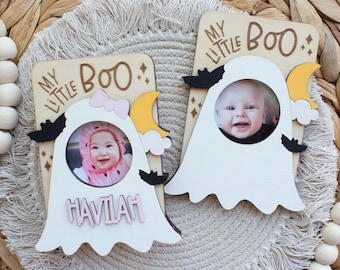 May include: Two white wooden ghost photo frames with a yellow crescent moon and black bats. The frames say "My Little Boo." One frame has a pink bow and the name "HAVILAH" written in pink letters.