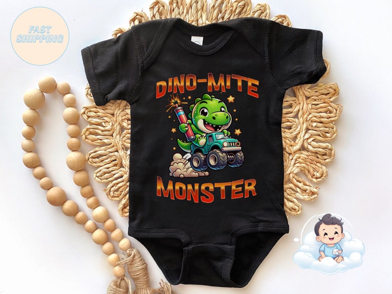 May include: Black short-sleeved bodysuit with a green dinosaur driving a monster truck. The text "Dino-mite Monster" is printed on the bodysuit.