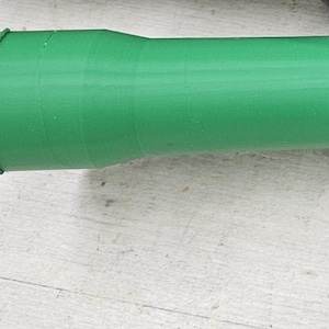 May include: A black and green Festool electric router with a dust collection hose attached. The router has a green and black handle and a silver base with the word "Festool" printed on it.