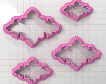 May include: Set of four pink plastic cookie cutters shaped like a stylized flower with a scalloped edge.